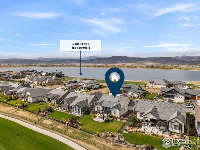 birds eye view of property featuring a residential view and a water and mountain view