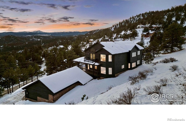 snowy aerial view with a mountain view