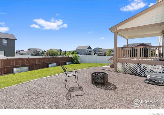 view of patio / terrace with a wooden deck and a fire pit