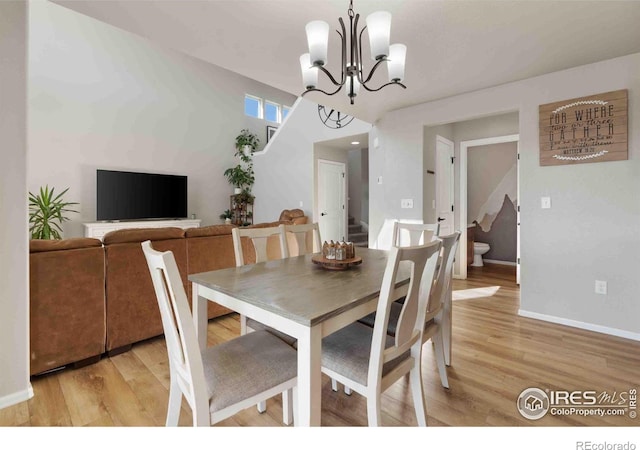 dining room featuring a chandelier and light wood-type flooring