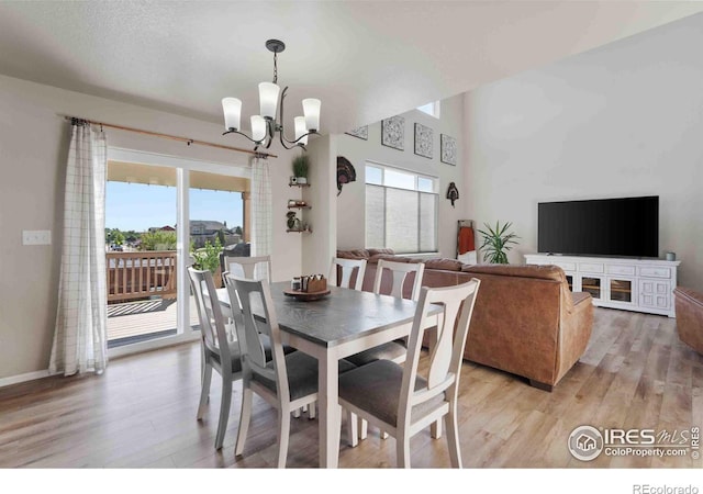 dining space featuring a wealth of natural light, a chandelier, and light hardwood / wood-style flooring