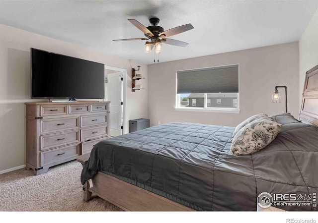 bedroom featuring light colored carpet and ceiling fan