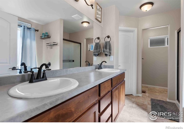 bathroom featuring vanity and an enclosed shower