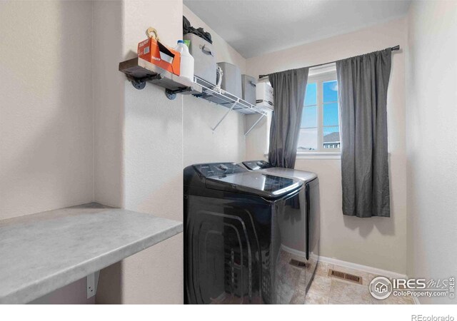 laundry area with washing machine and dryer