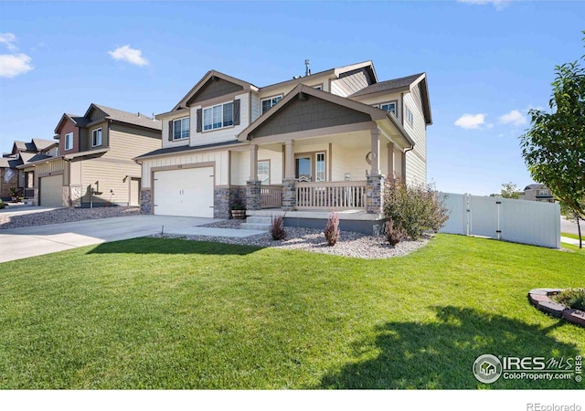 craftsman-style house featuring a garage, a front yard, and covered porch