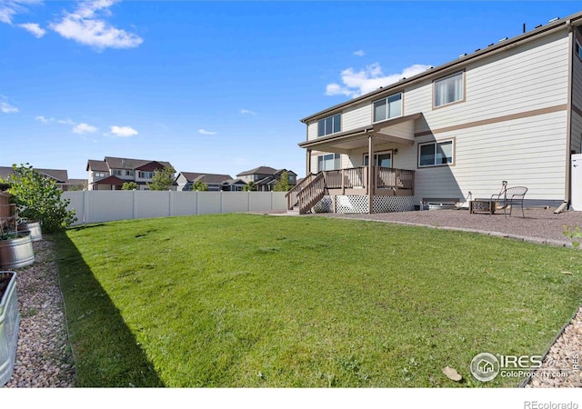 view of yard featuring a wooden deck and an outdoor fire pit