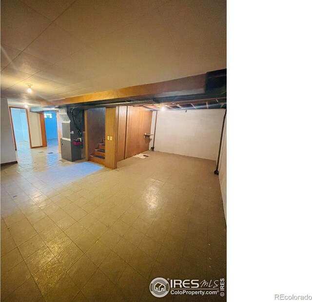 180 W 3rd St S, Cheyenne Wells, CO 80810 - finished basement featuring heating unit, stairway, and tile patterned floors