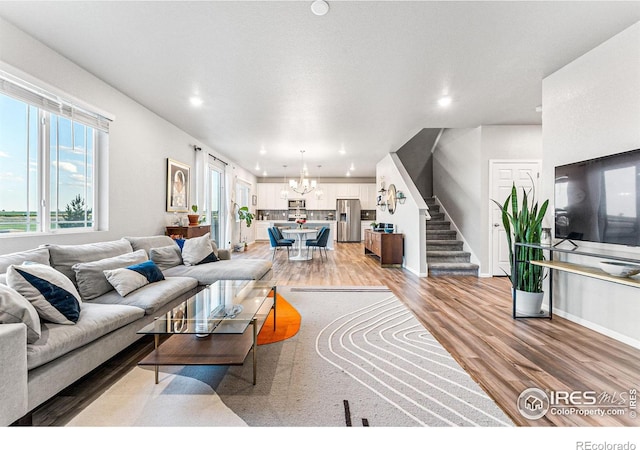 living room featuring a notable chandelier and hardwood / wood-style flooring