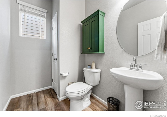 bathroom featuring hardwood / wood-style floors, sink, and toilet