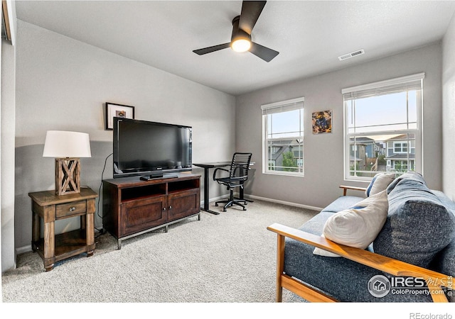 carpeted living room with ceiling fan