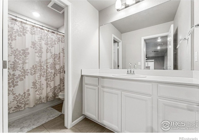 full bathroom featuring vanity, toilet, tile patterned flooring, and shower / tub combo