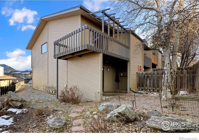 rear view of property with a balcony