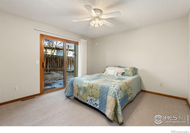 bedroom featuring ceiling fan, a textured ceiling, carpet floors, and access to outside