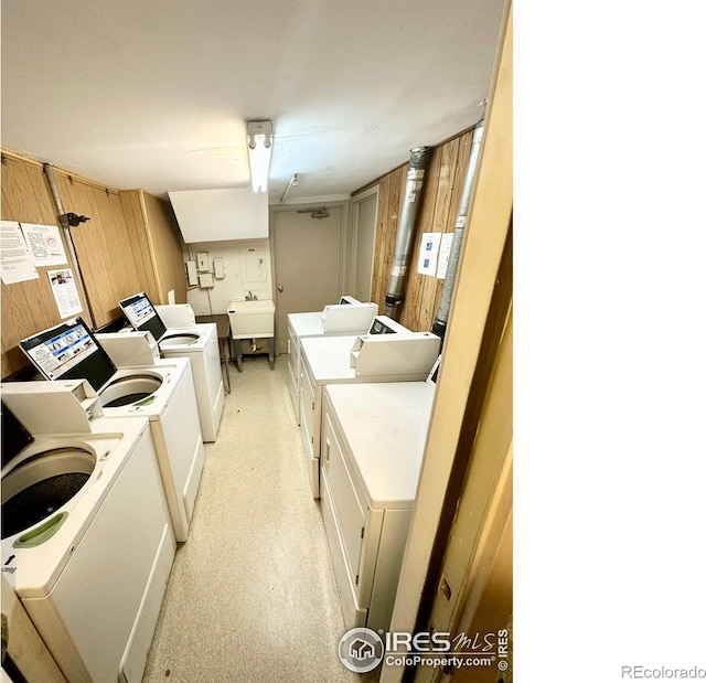 laundry room with independent washer and dryer and sink