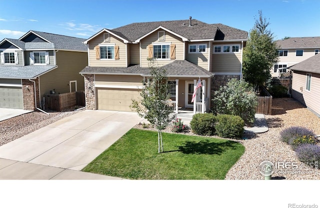 view of front of home featuring a front lawn, a garage, and a porch