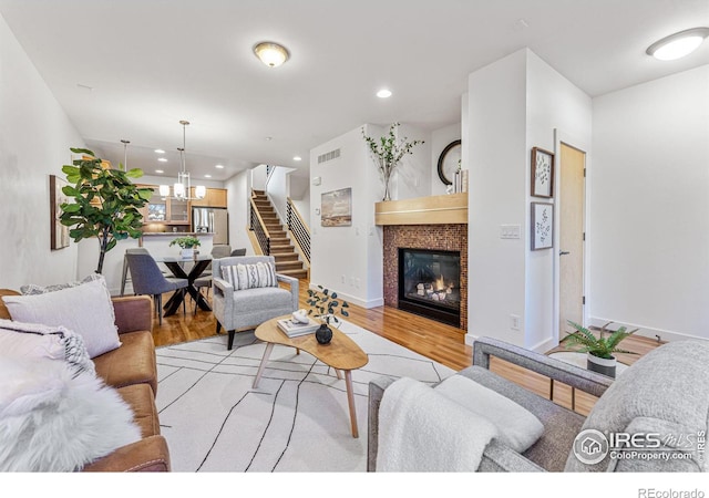 living room featuring light hardwood / wood-style floors and a notable chandelier