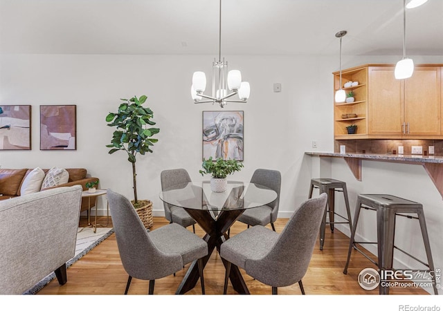 dining area featuring a chandelier and light hardwood / wood-style flooring