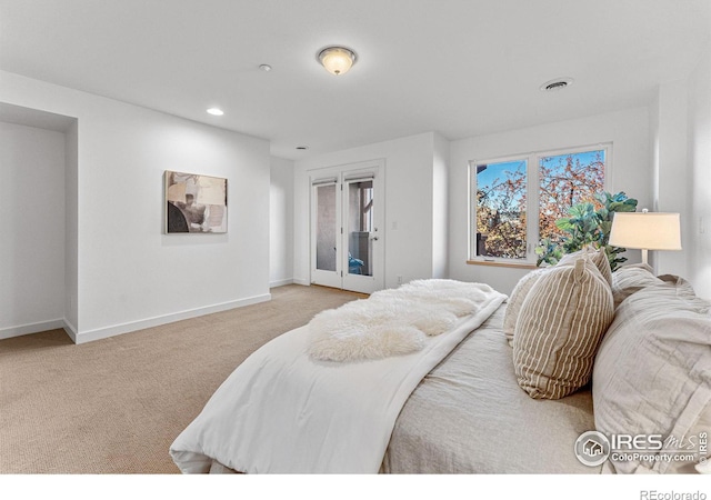 bedroom featuring access to exterior and light carpet