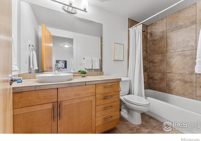 full bathroom with tile patterned flooring, shower / tub combo, vanity, and toilet