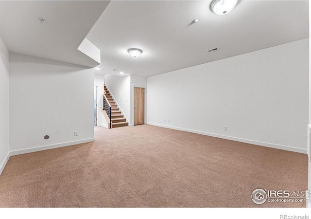 basement featuring light colored carpet