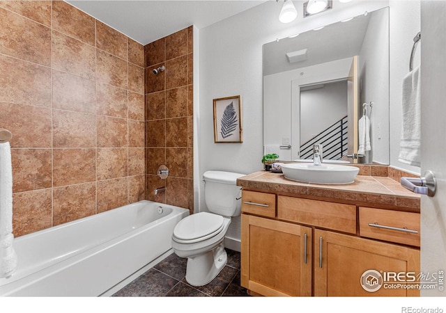 full bathroom with tile patterned flooring, vanity, tiled shower / bath combo, and toilet