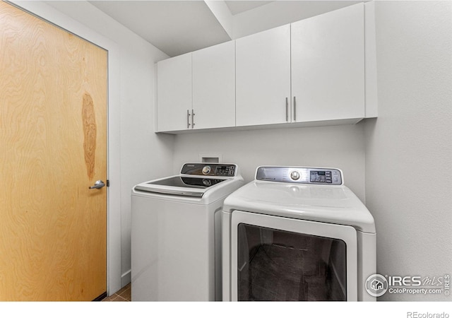 laundry room with cabinets and washer and dryer