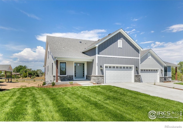 craftsman-style house featuring a garage, a front yard, and covered porch