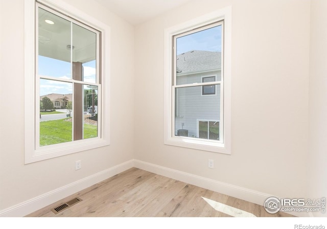 empty room with light hardwood / wood-style floors