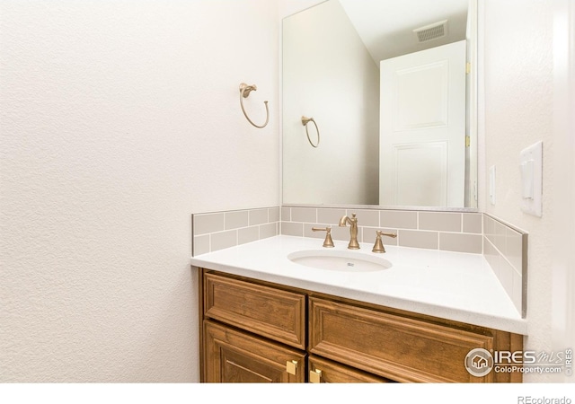 bathroom featuring tasteful backsplash and vanity