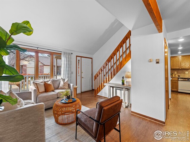 living room with beam ceiling and light wood-type flooring