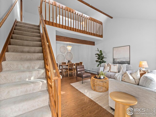 living room featuring hardwood / wood-style flooring, high vaulted ceiling, baseboard heating, and beamed ceiling