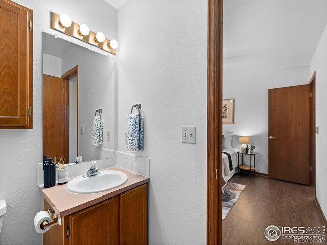 bathroom with vanity and hardwood / wood-style flooring