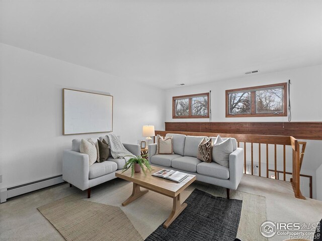 living room with light carpet and a baseboard radiator