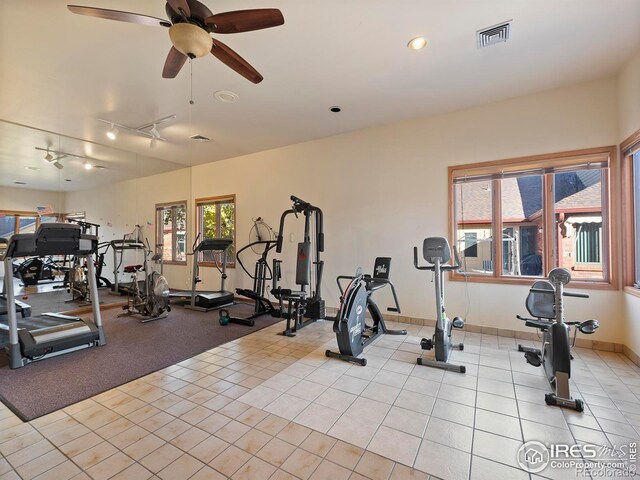 workout area with light tile patterned flooring and ceiling fan