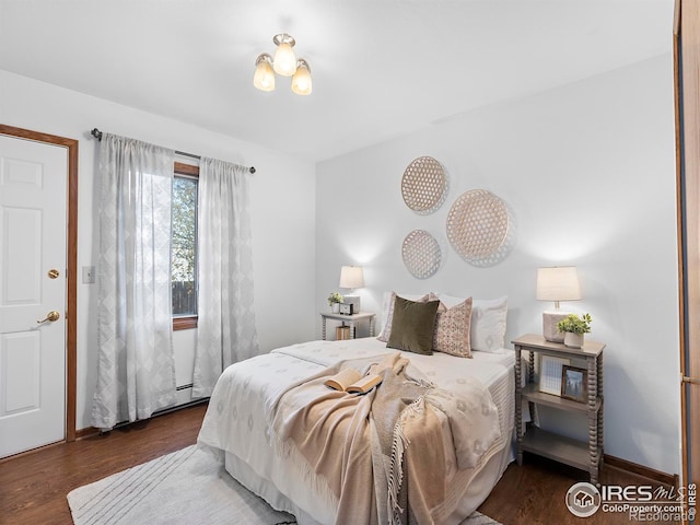 bedroom with dark hardwood / wood-style flooring