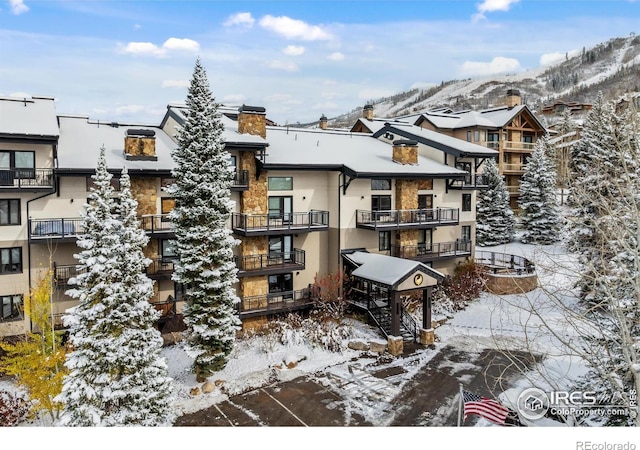 snow covered building with a mountain view