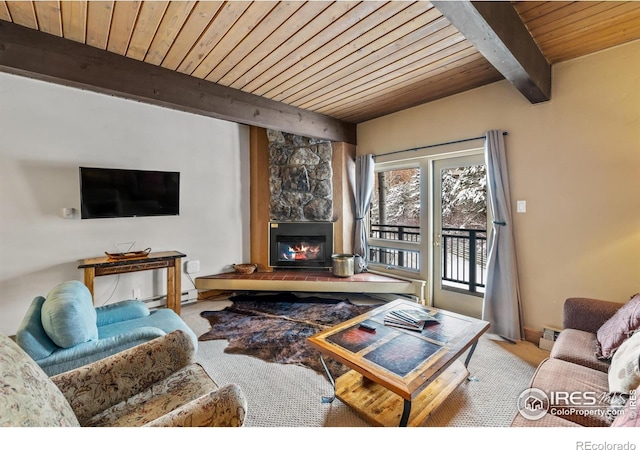 carpeted living room featuring a stone fireplace, wood ceiling, and beam ceiling