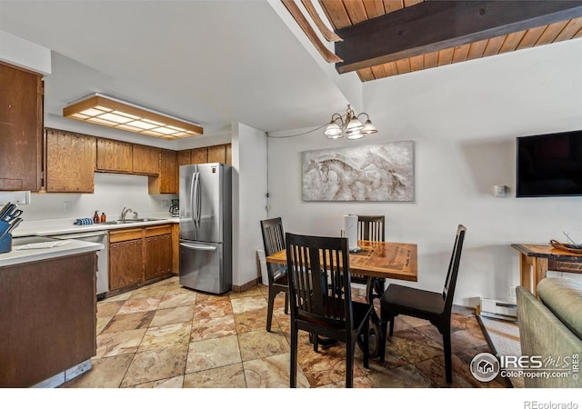 kitchen with wooden ceiling, stainless steel refrigerator, beam ceiling, an inviting chandelier, and a baseboard heating unit