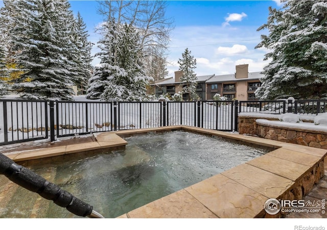 snow covered pool with a jacuzzi