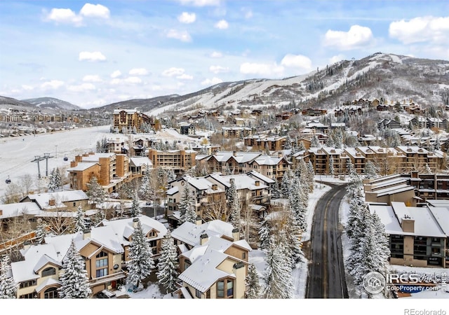 snowy aerial view with a mountain view