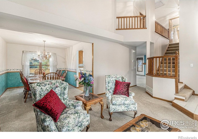 living room featuring carpet flooring and an inviting chandelier