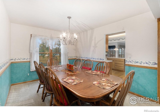 dining area featuring carpet floors and a notable chandelier