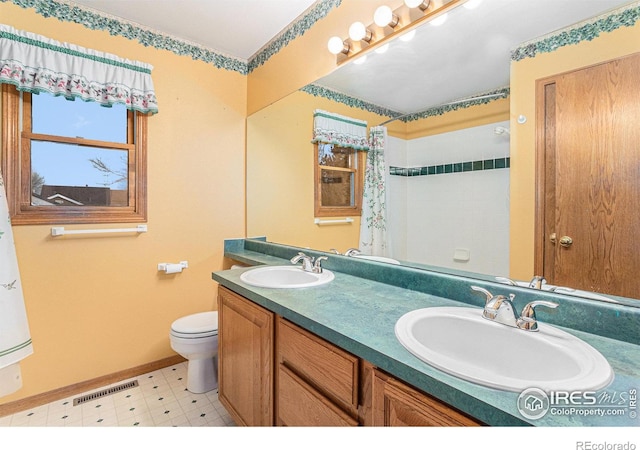 bathroom featuring toilet and vanity