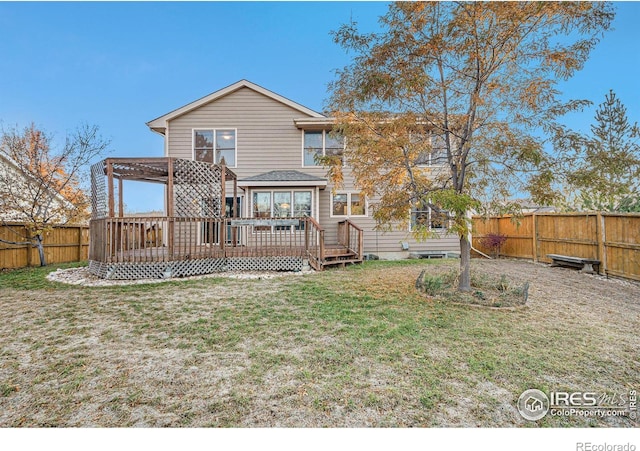 rear view of property featuring a pergola, a yard, and a deck