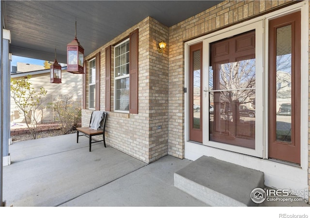 view of exterior entry featuring a porch