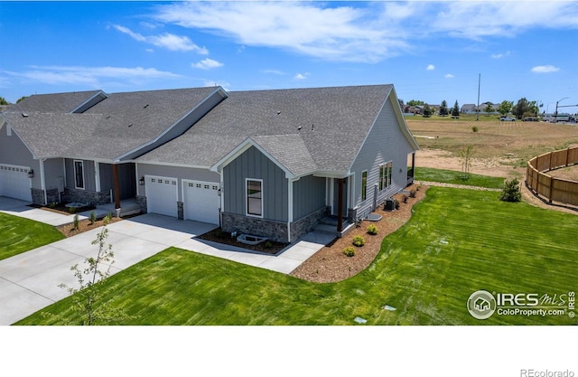 craftsman house with cooling unit, a garage, and a front yard