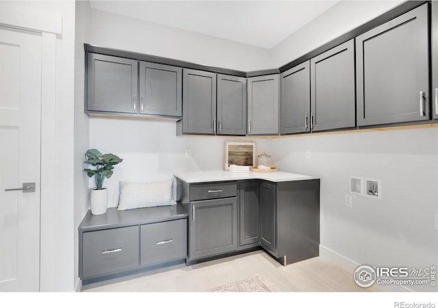 clothes washing area featuring cabinets and hookup for a washing machine