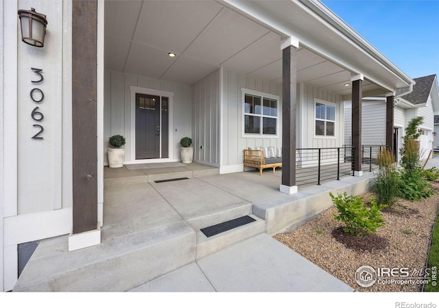 view of exterior entry featuring a porch