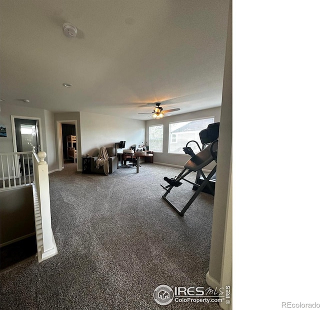 workout room with carpet flooring, a textured ceiling, and ceiling fan