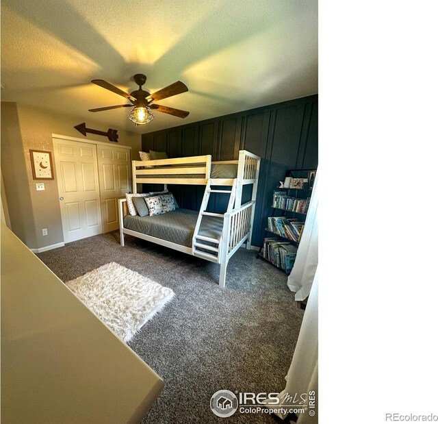 carpeted bedroom featuring ceiling fan, a textured ceiling, and a closet